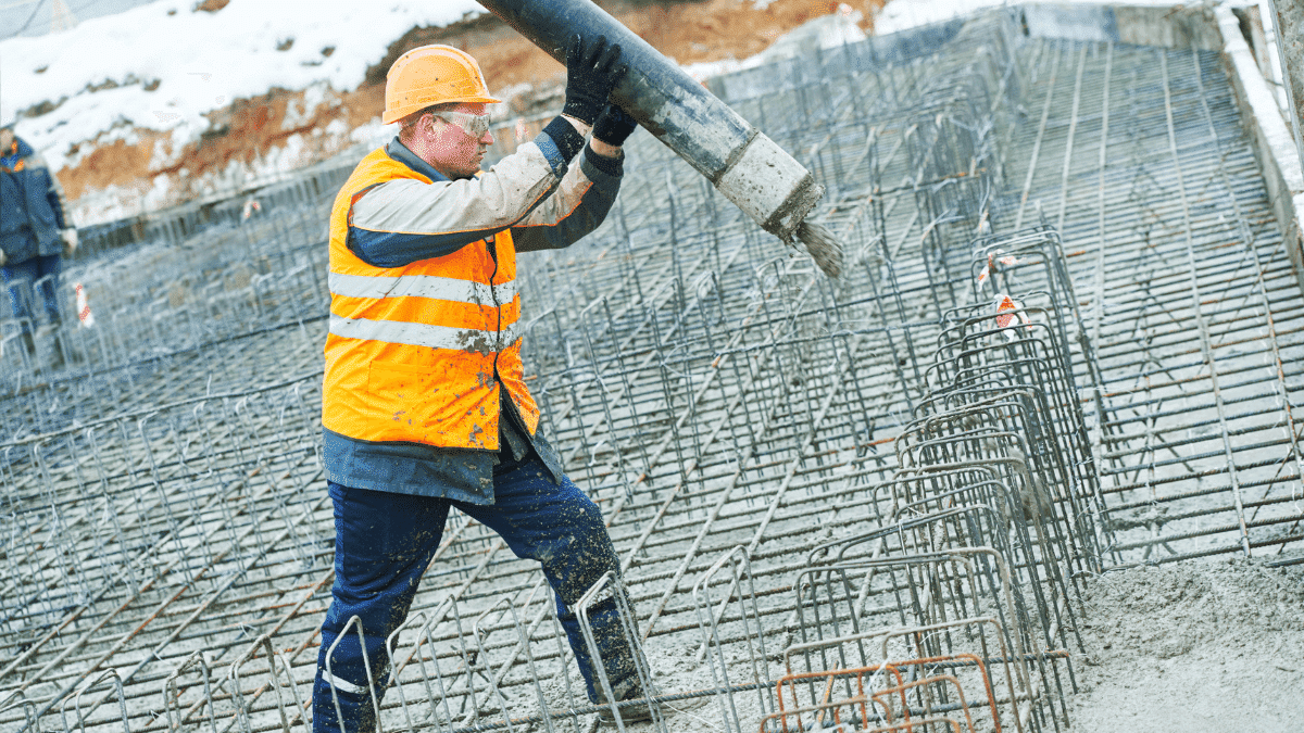 Self-made chute for concreting works. Concrete pours down a wooden